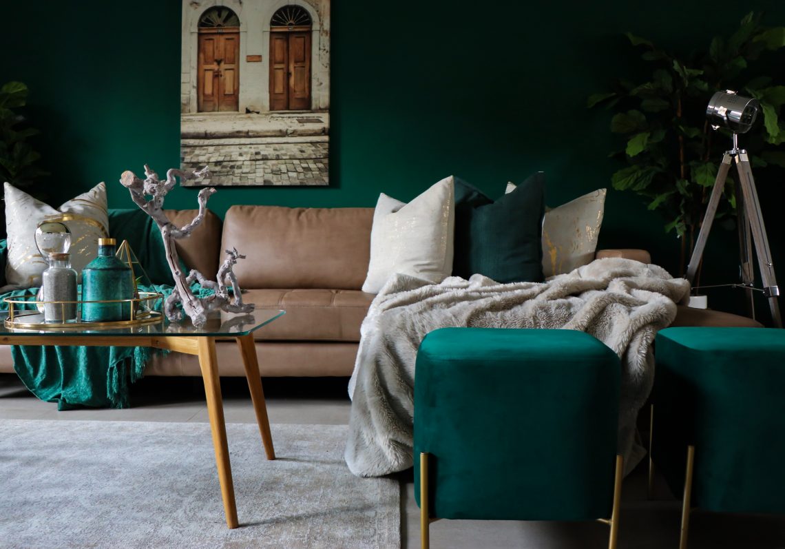 green and gold living room decor with green couch and green walls