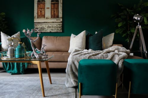 green and gold living room decor with green couch and green walls