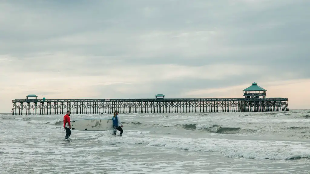 surfers on folly beach in charleston sc